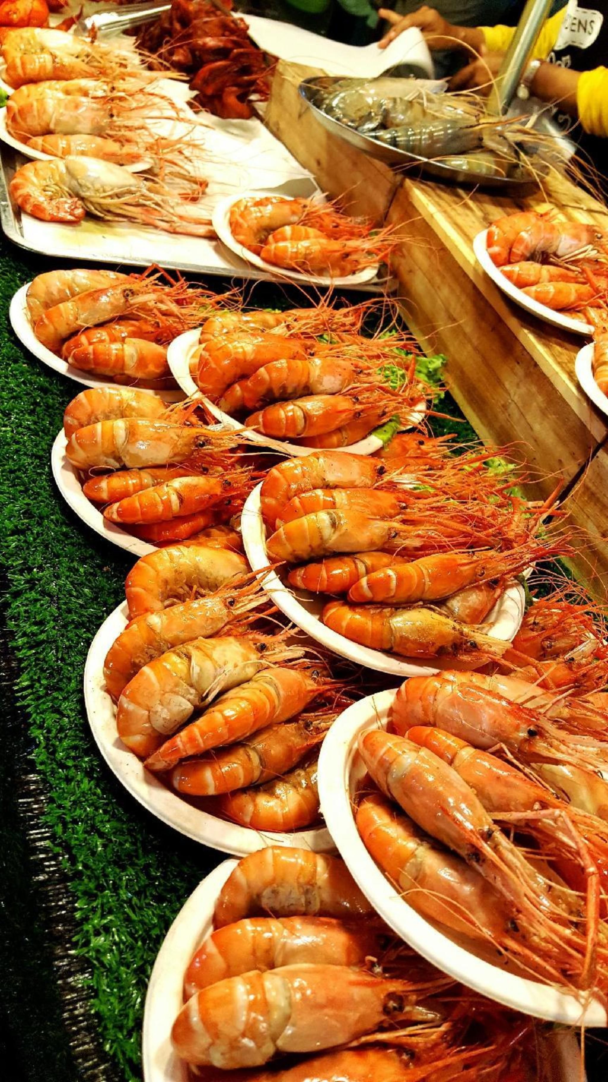 A display of cooked shrimp arranged on plates.