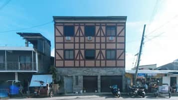 A two-story building with a symmetrical facade, multiple windows, and a ground-level entrance.