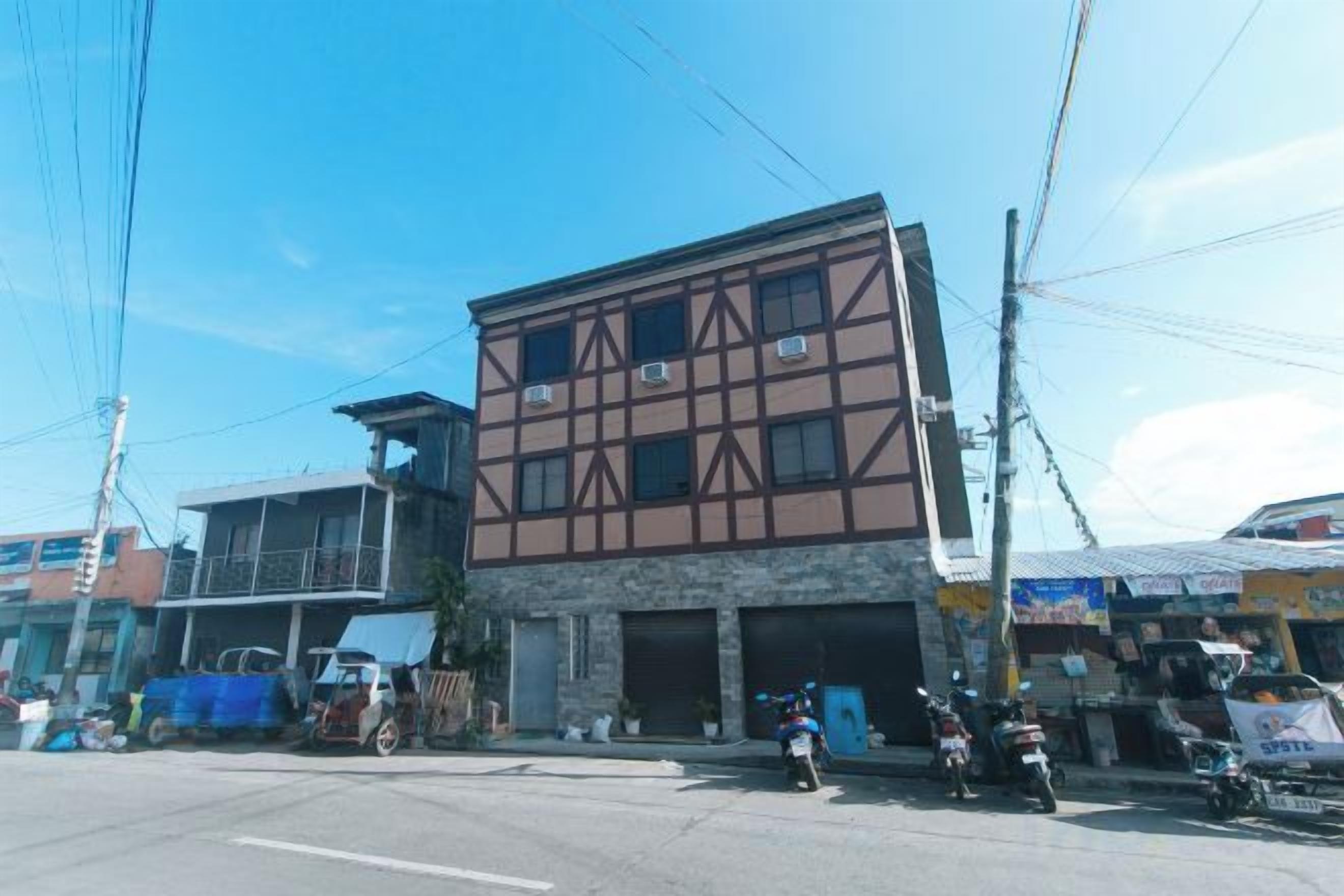 A two-story building with a commercial ground floor and residential upper floors.