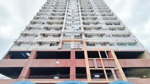 A high-rise building with multiple floors, balconies, and a central open space. - San Marino JY7 Rentals by RedDoorz (Cebu City)