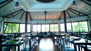 A spacious dining area with high ceilings, large windows, and a central air conditioning unit. - Vuon Thu Do Homestay (Buon Ma Thuot)