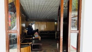 A room with a high ceiling, wooden furniture, and a patterned floor. - Hotel Dreamland (Udhampur)