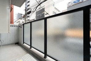 A corridor with a metal railing and a control panel. - Blossom Terrace Ryogoku (Tokyo)