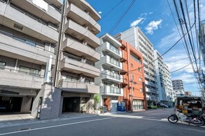 A multi-story building with a modern architectural style, featuring balconies and a flat facade. - Blossom Terrace Ryogoku (Tokyo)