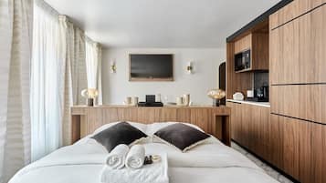 Desk, iron/ironing board, bed sheets