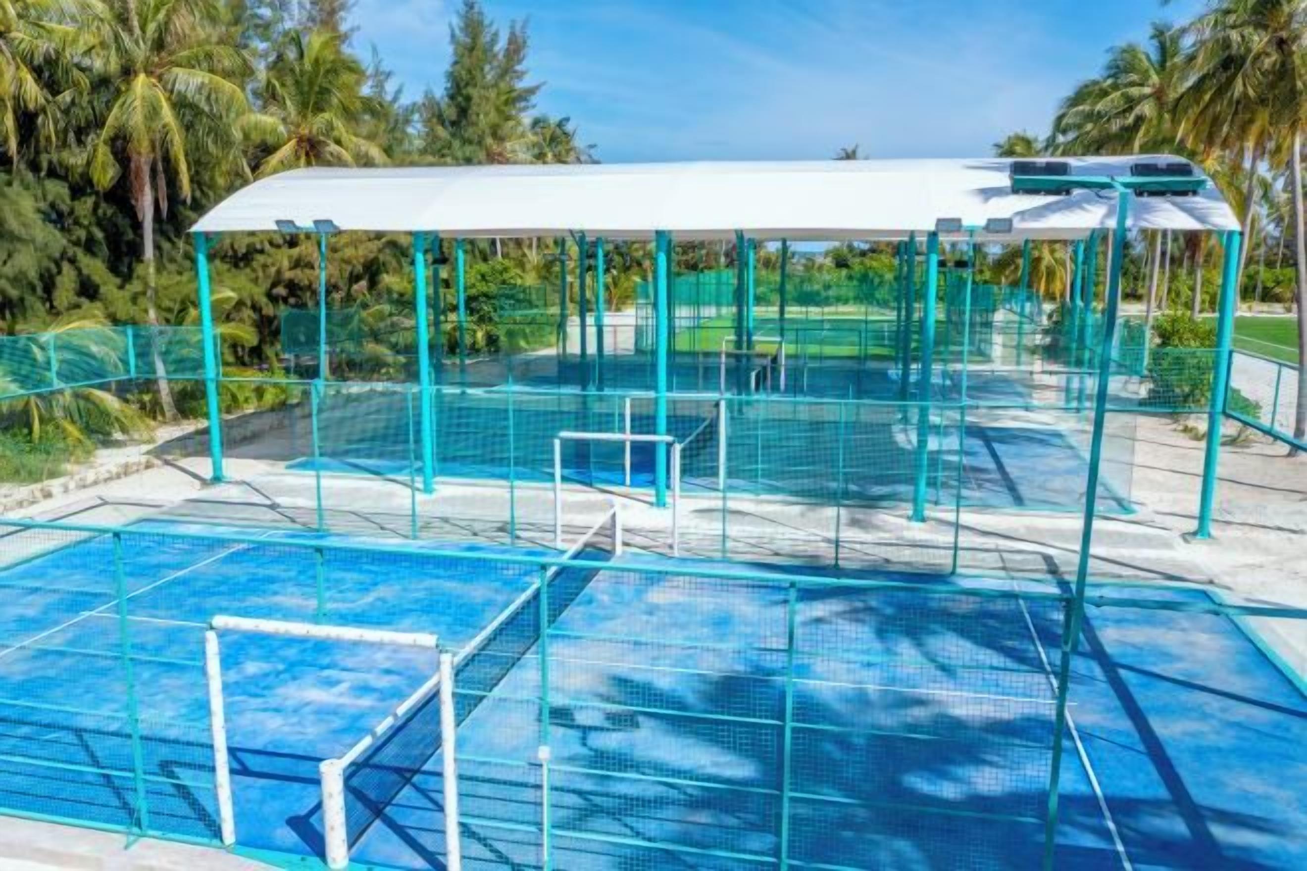 A swimming pool with a covered area and a goalpost.