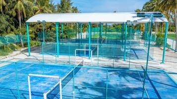 A swimming pool with a covered area and a goalpost.