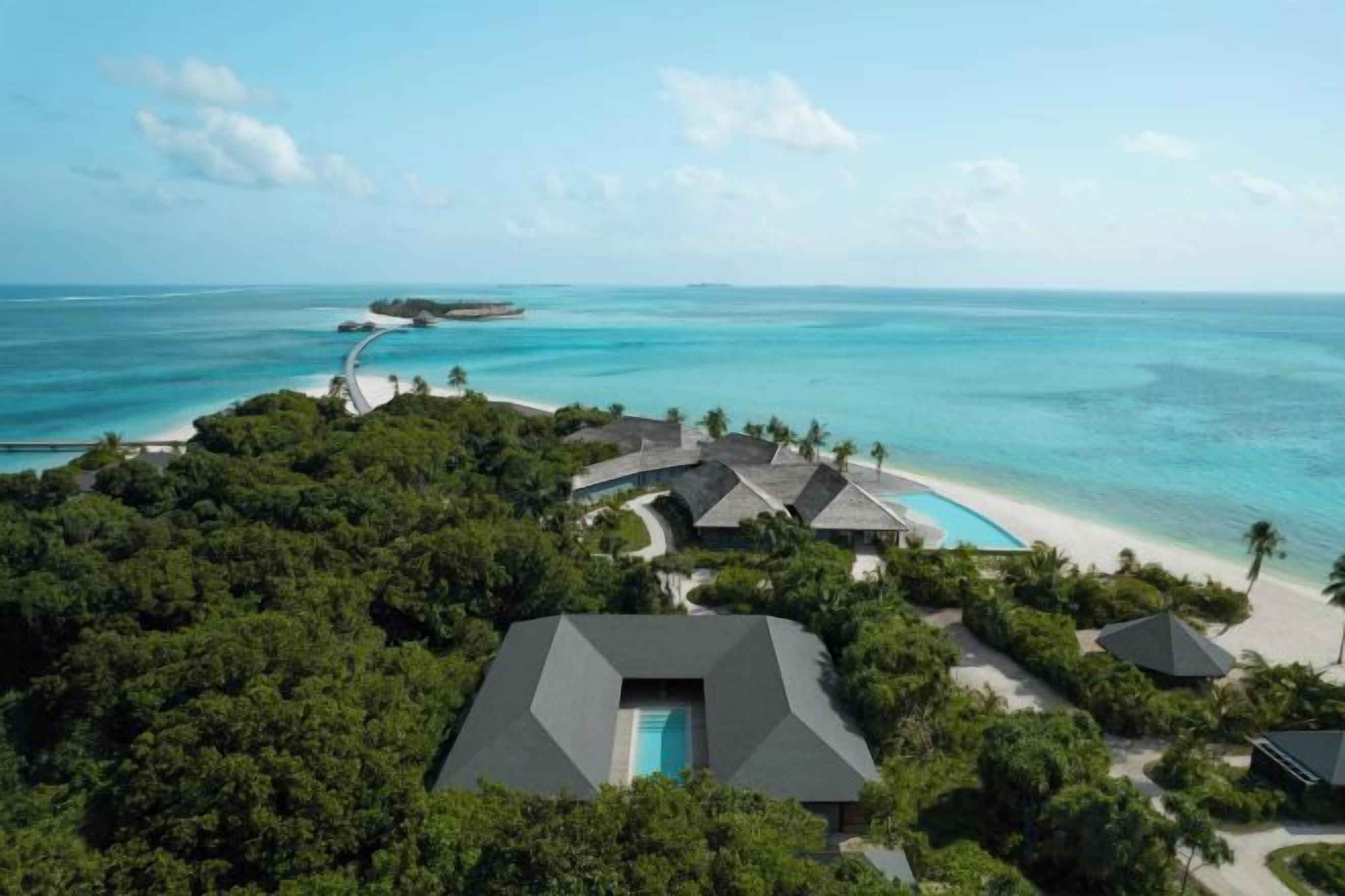 A resort with multiple buildings, a swimming pool, and a beach.