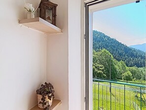 A balcony with a view of a forested mountain range. - Apartment Festér by Interhome (Ragoli)
