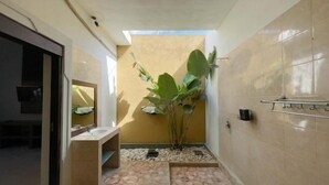 A bathroom with a sink, mirror, and a plant. - The Lavana Bali Radiance Arjuna Villa Seminyak (Bali)