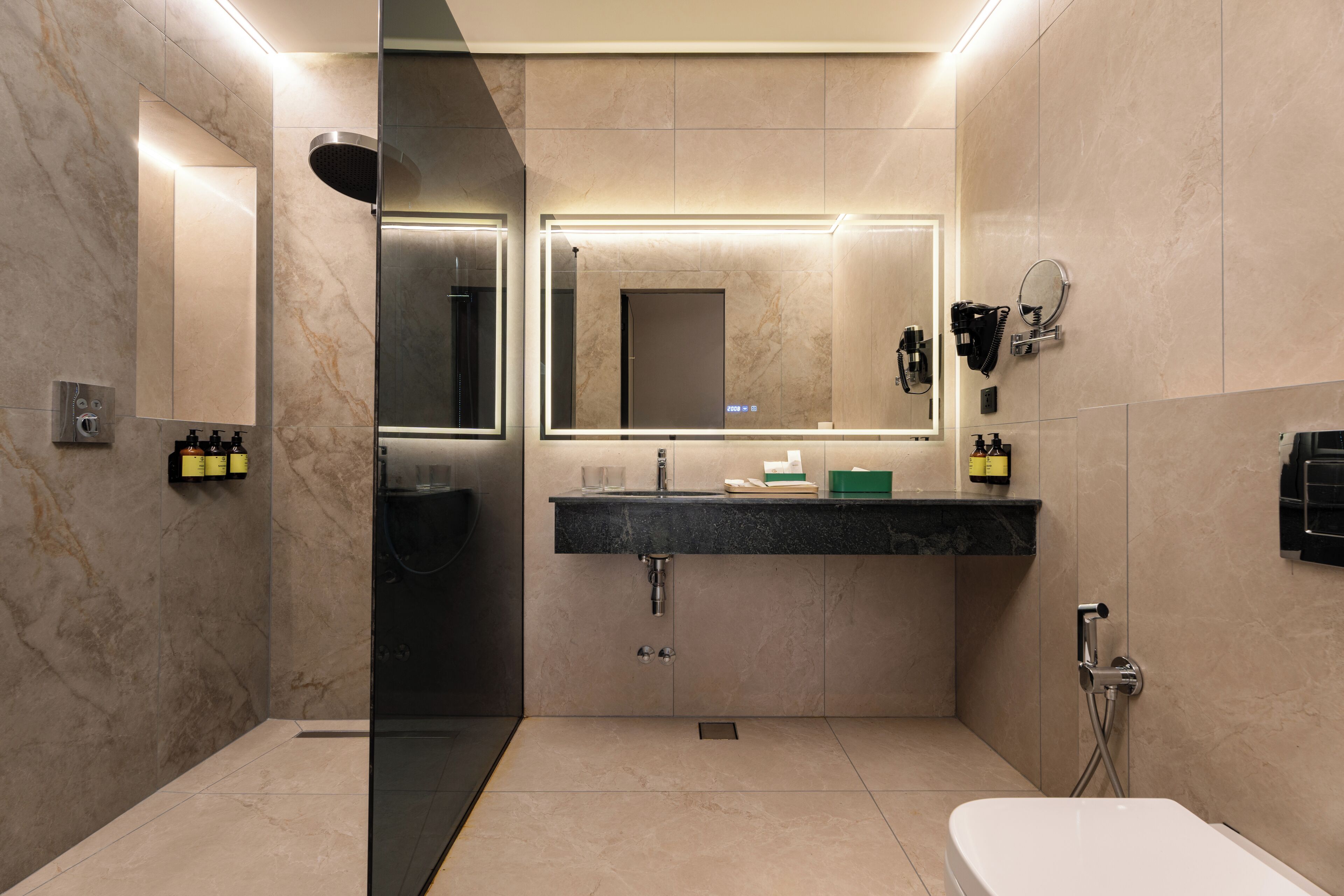 A modern bathroom with a glass-enclosed shower, a vanity with a mirror, and a bathtub.