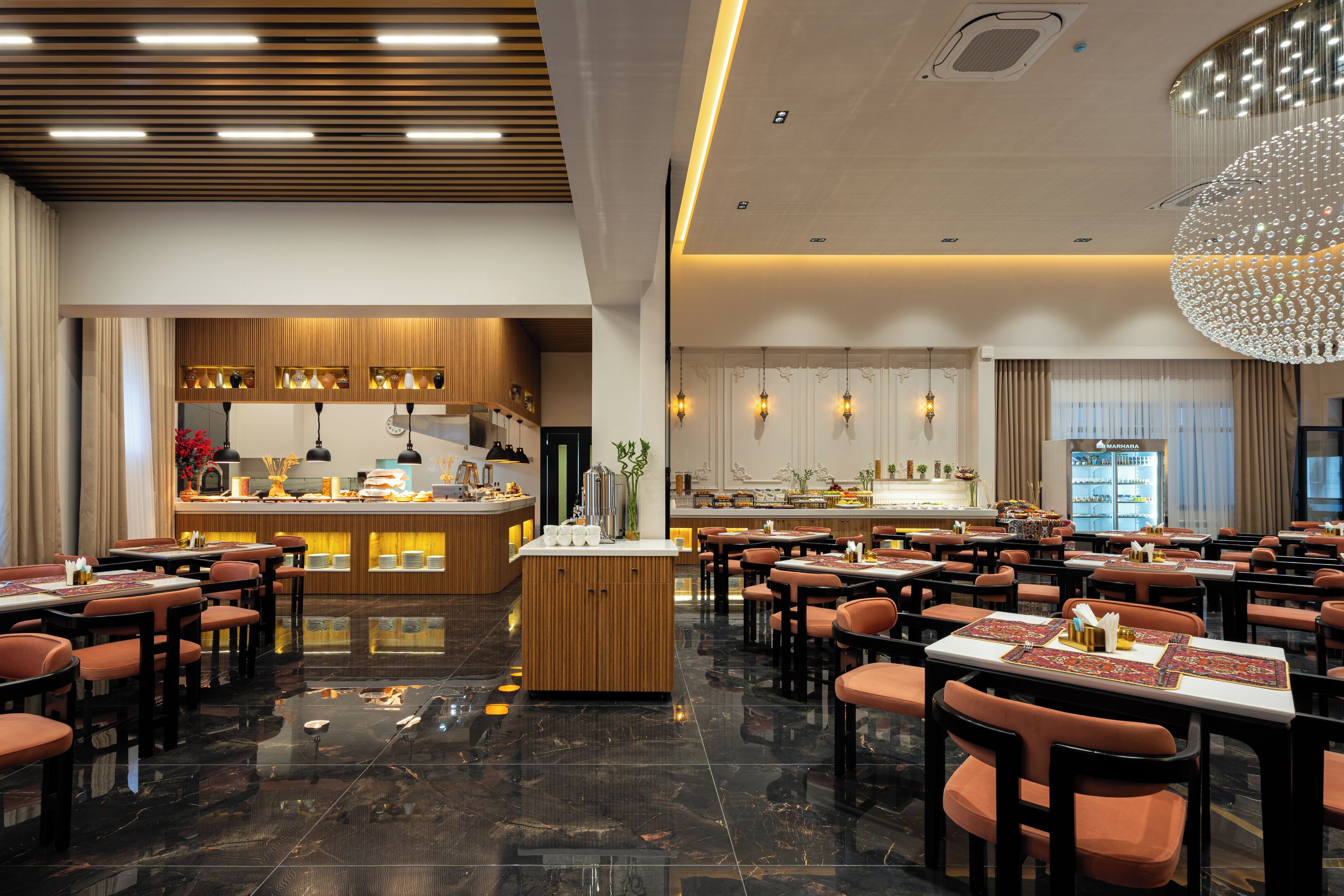 A spacious restaurant with a central bar, multiple dining tables, and a polished floor.