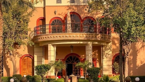 A large building with a pool, arched windows, and a balcony. - Charming Luxury Villa | Pool & Hot Tub (Marrakesh)