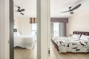 A hotel room with two beds, a city view, and ceiling fans. - High-Rise Sea-View Stay by Sea N' Rent (Tel Aviv)
