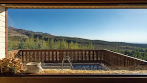 A wooden deck with a view of mountains and trees. - Silver Valley (Kumushkan)