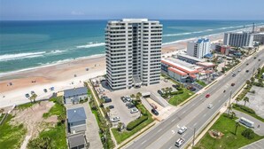 A high-rise hotel with multiple floors, a beach view, and a parking area. - Roomy Oceanfront 2/2 condo with Million Dollar views in fabulous Daytona Beach!! (Daytona Beach)