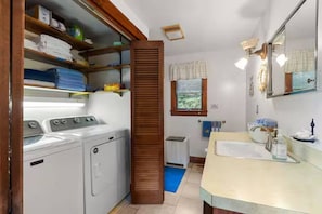 A laundry room with stacked laundry, a washing machine, and a dryer. - Merrymeeting Lake Private Beach, Gazebo & Hot Tub (New Durham)