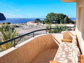A balcony with a view of the beach, a sofa, and a railing. - Vacation Apartment 'Costamar Oceanview 1 Bed' with Sea View, Shared Pool and Wi-Fi (Los Cristianos)