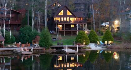 Family-friendly lakefront cabin/chalet with incredible views, private beach, lakeside firepit, boats, hot tub, multiple game rooms, and more
