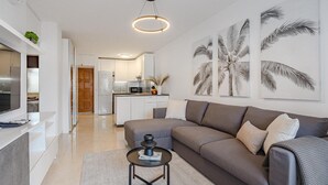 A modern living room with a sofa, coffee table, and artwork.