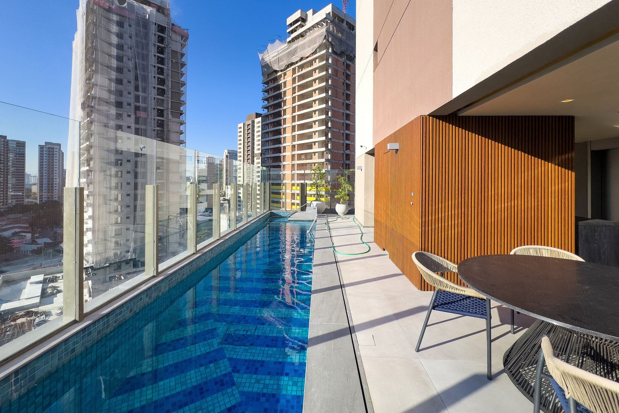 A rooftop pool with a view of surrounding high-rise buildings.