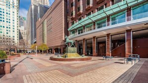 A public square with a central fountain, surrounded by modern buildings and outdoor seating areas. - The Buckingham Athletic Club & Hotel (Chicago)