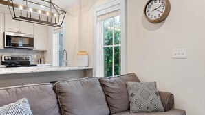 A modern kitchen with a built-in microwave, a stainless steel oven, and a pendant light fixture. - 2bd Home, Large Private Backyard + Blocks to King! (Charleston)