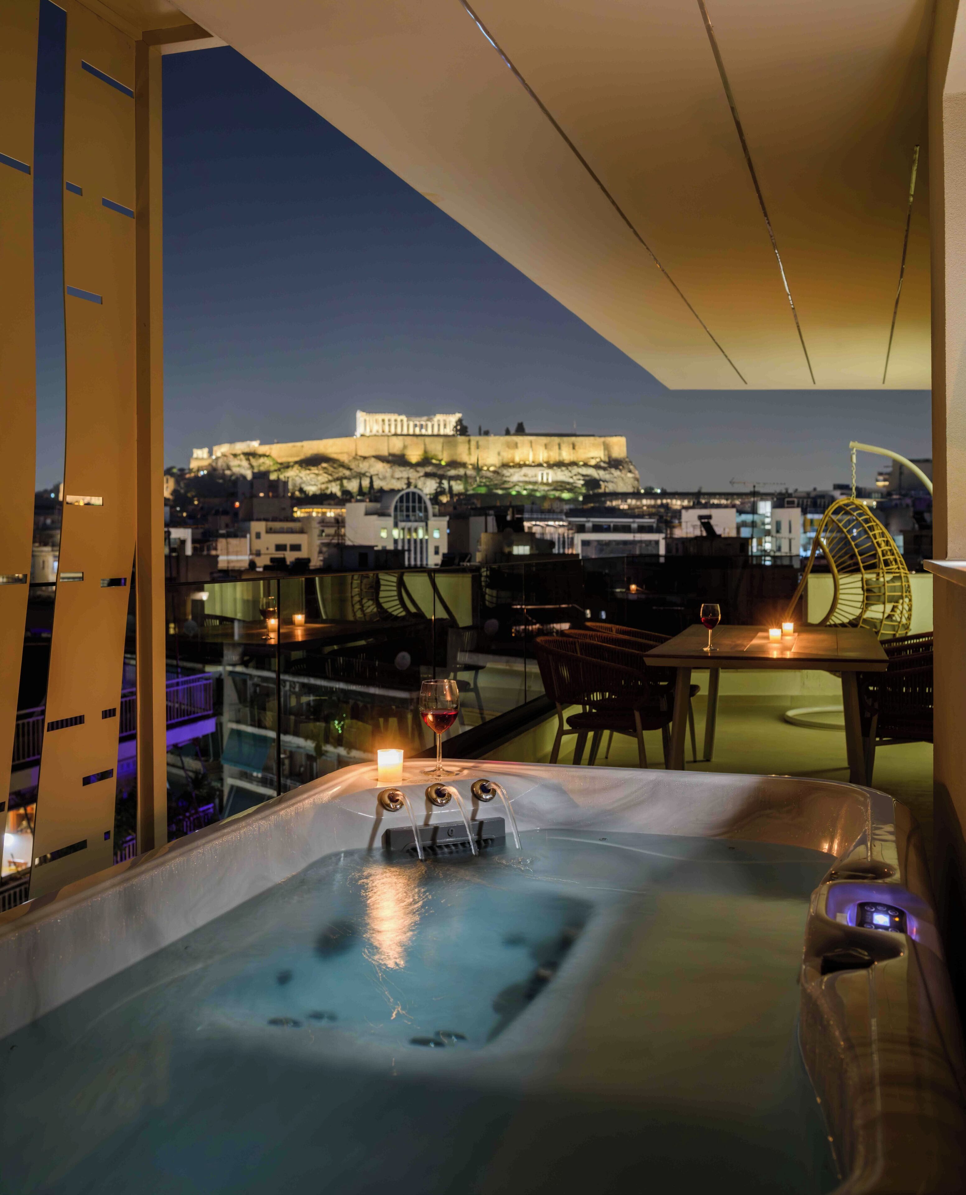 A hot tub with a view of a historic building at dusk.