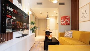 Deluxe Apartment, 1 King Bed, Lake View | Living area | 120-inch Smart TV with satellite channels