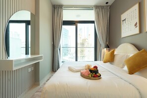 A hotel room with a large bed, a bedside table, a mirror, a window with curtains, and a city view. - Lake-View 1BR Retreat in Business Bay  (Dubai)