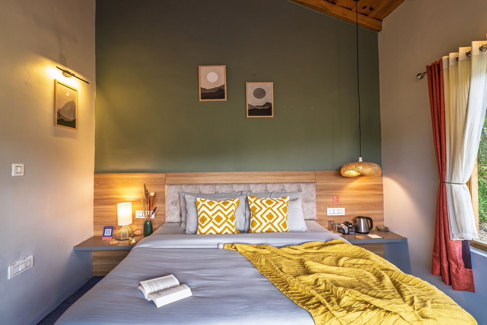 A neatly arranged bedroom with a bed, bedside tables, and a nightstand.