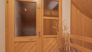 A wooden door with a frosted glass panel and a number "5" on it.