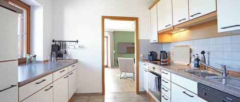 Fridge, stovetop, dishwasher, coffee/tea maker