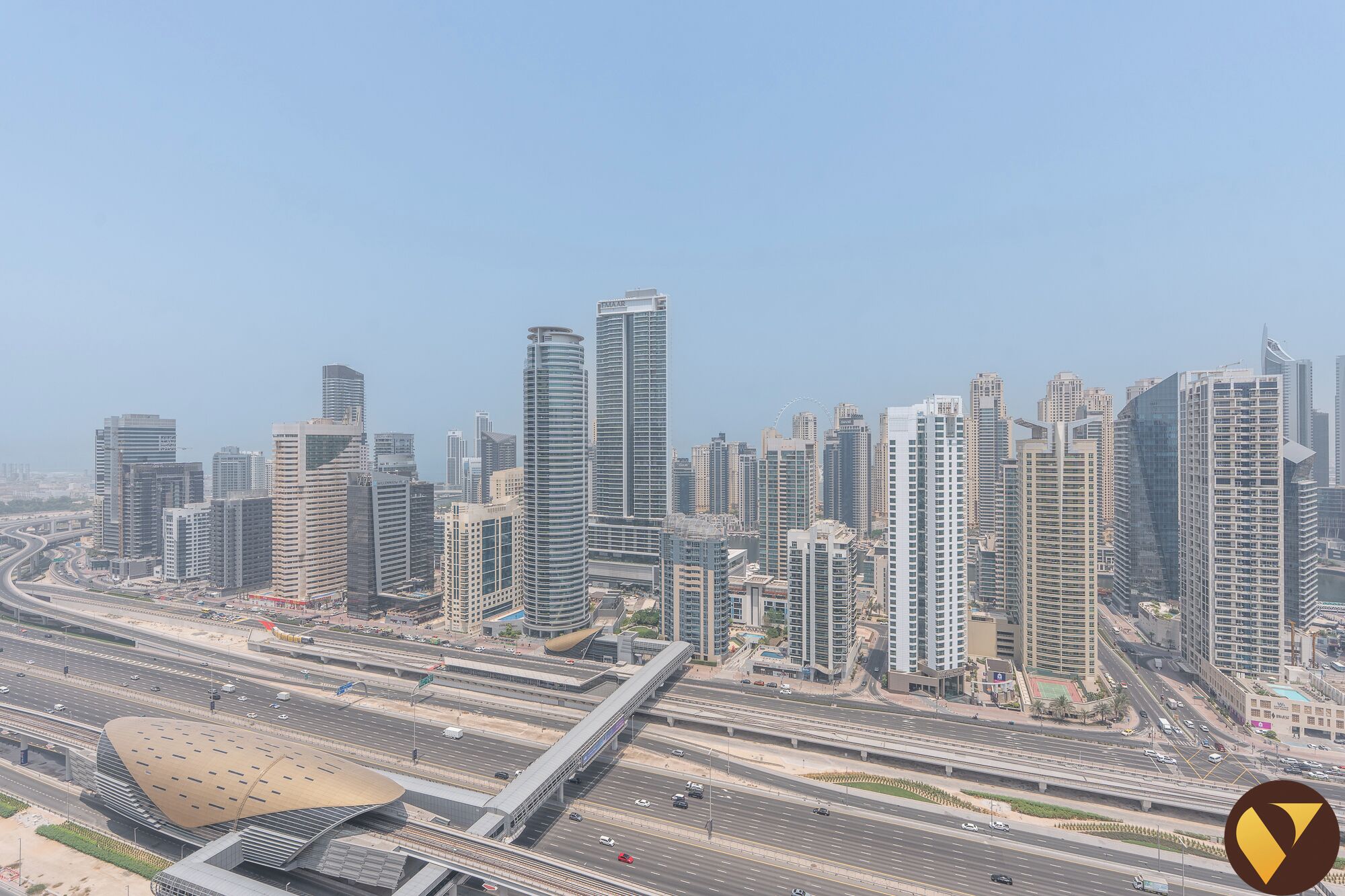 A cityscape with modern high-rise buildings and a complex highway system.