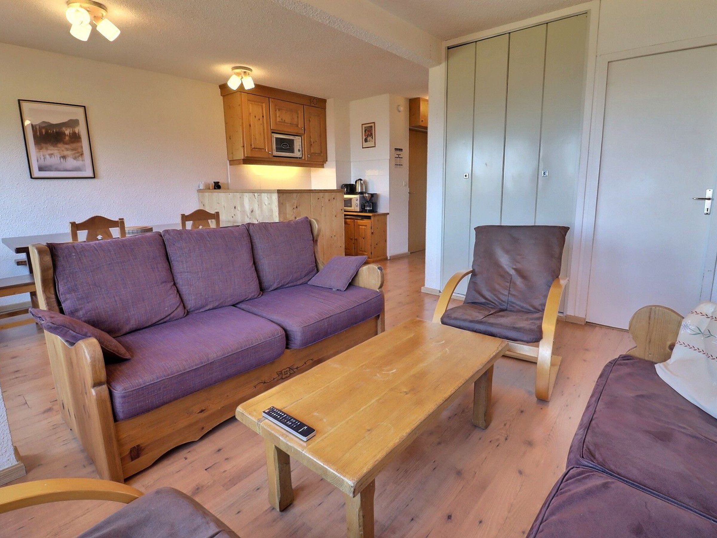 A cozy living room with a sofa, a wooden coffee table, and a chair.