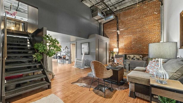 A spacious living area with a staircase, a dining area, and a seating area with a lamp and cushions. - Peaceful and Private Retreat (Lafayette)