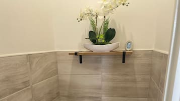 Shower, hair dryer, towels, toilet paper