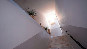 A staircase with a handrail, leading upwards. - Casa Manbrù by Studio Vita (Siculiana)