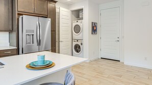 A modern kitchen with stainless steel appliances, a white countertop, and a wooden cabinet. - Lake + Mtn Views: Couple's Apt in Apache Junction (Apache Junction)