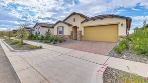 A residential house with a garage, a driveway, and landscaped garden. - Lake + Mtn Views: Couple's Apt in Apache Junction (Apache Junction)