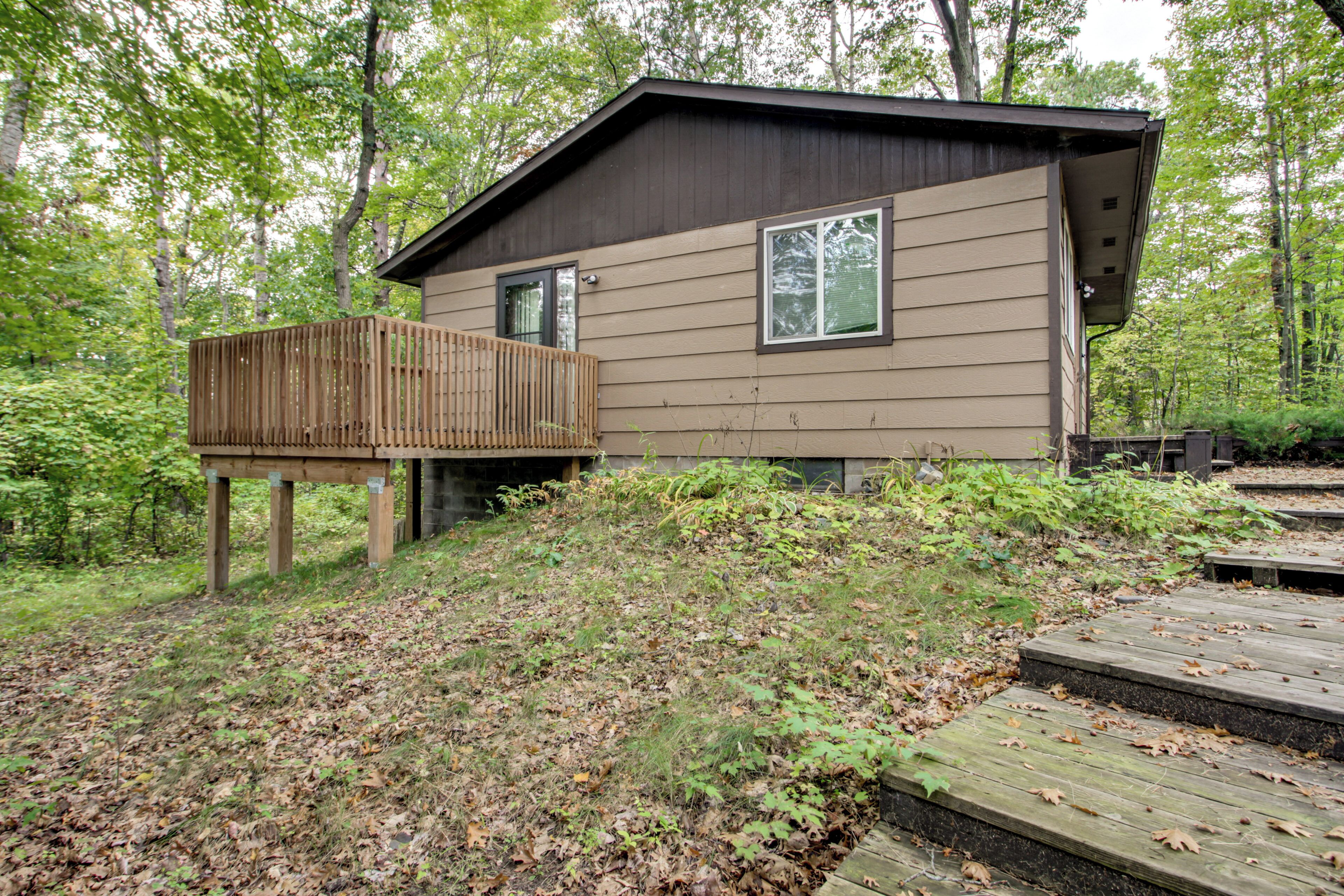 A cabin with a deck and a small window.
