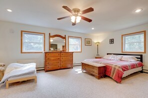 A bedroom with a bed, dresser, and ceiling fan. - Lakefront Family Home w/ Dock, Views: Pet-friendly (Conover)