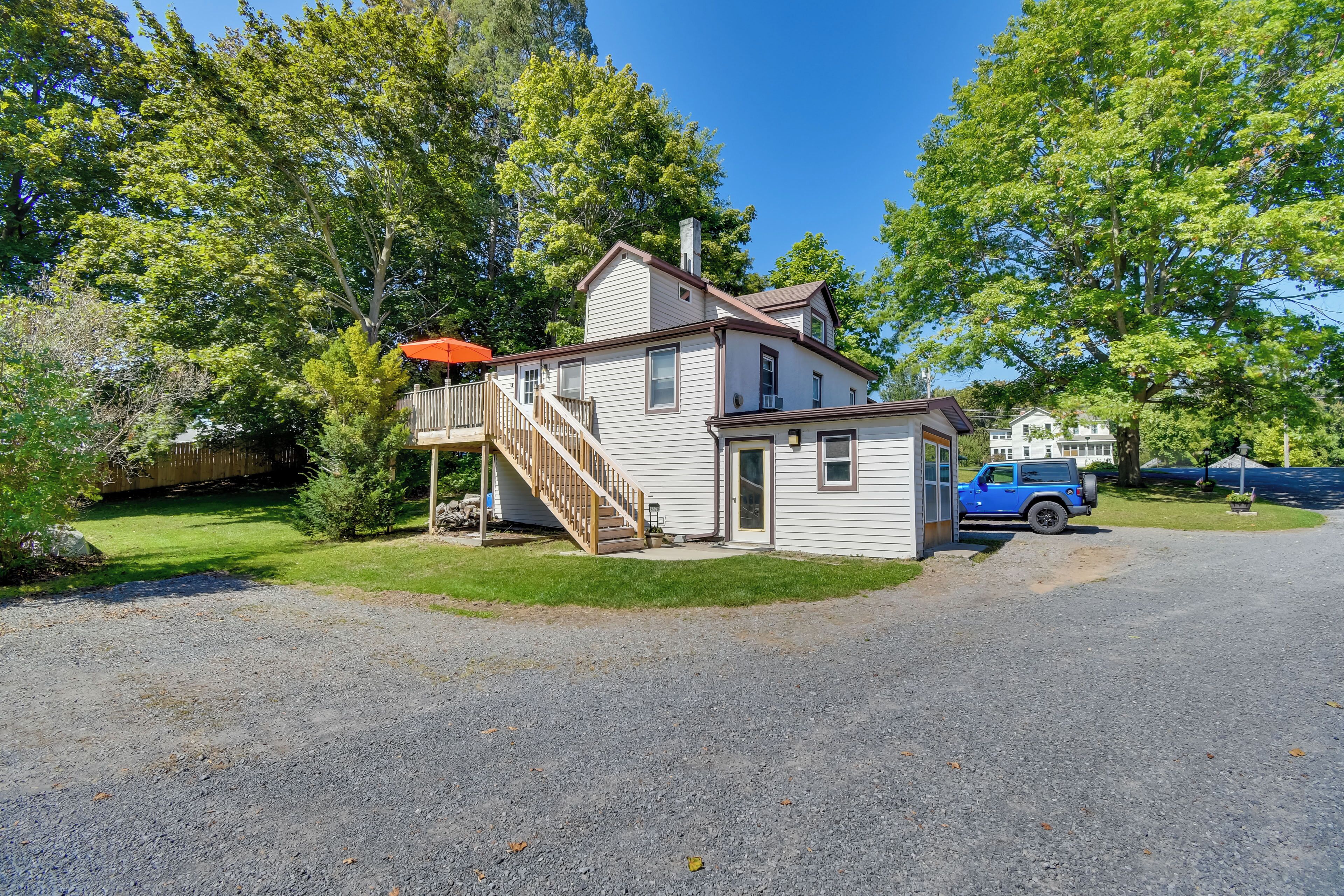A two-story house with a front porch, a small attached garage, and a driveway.