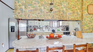 A kitchen with a central island, white cabinets, and a patterned backsplash. - Rural Retreat: Cypress Lake By Roosevelt St Park (Morton)