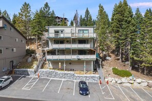 A multi-story building with a balcony on the second floor, surrounded by trees. - Tahoe condo across from Heavenly Stagecoach Lodge- (Stateline)