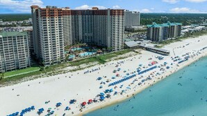A coastal resort with high-rise buildings, a sandy beach, and a clear blue sky. - Emerald Tide Retreat 327-Gulf Views-Sleeps 6 (Panama City Beach)