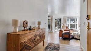 A spacious living room with a wooden cabinet, a sofa, and a coffee table. - Mountain Comfort Steps From the Action (Keystone)