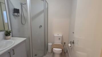 Shower, hair dryer, towels, toilet paper