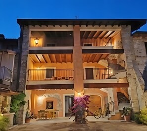A multi-story building with a central courtyard, balconies, and a staircase.