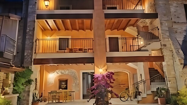 A multi-story building with a central courtyard, balconies, and a staircase. - Apartment 'Il Borgo Ulivo' with Lake View, Wi-Fi and Air Conditioning (Castelletto)